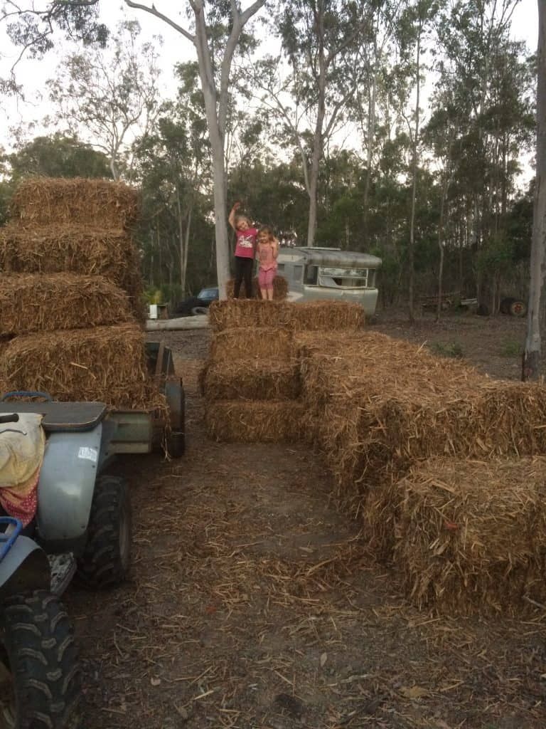 stacking hay bales in the garden