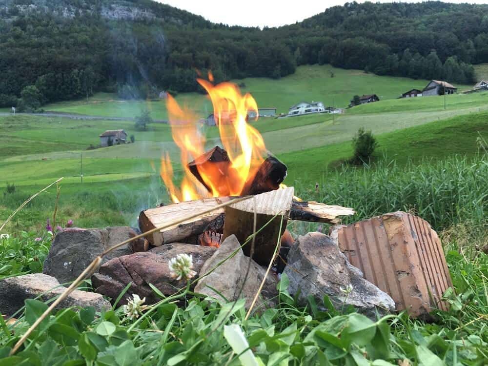 campfire in grass with rocks in switzerland