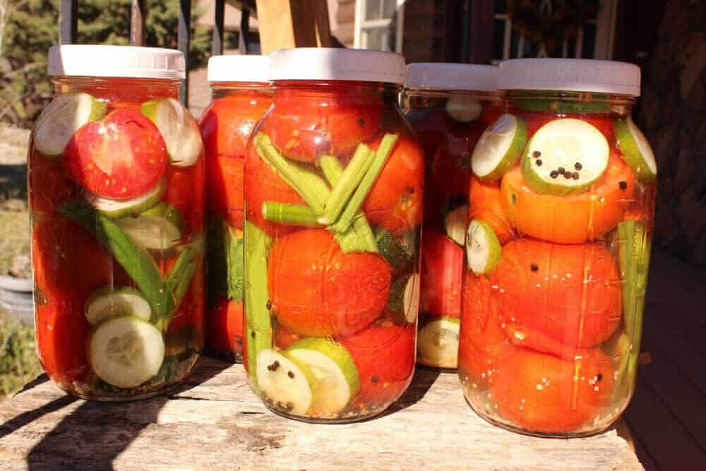 jars of delicious fermented tomatoes and cucumbers