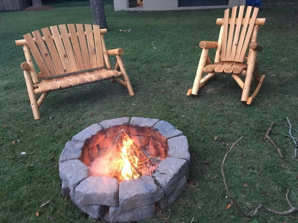 lovely fire pit in backyard wooden chairs