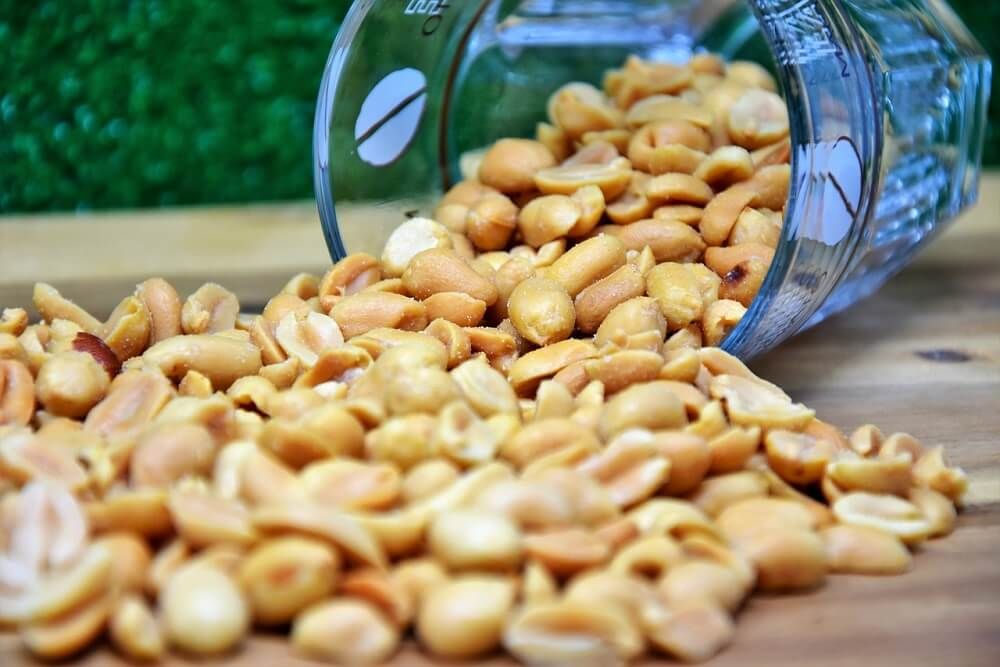 yummy roasted peanuts on wooden table