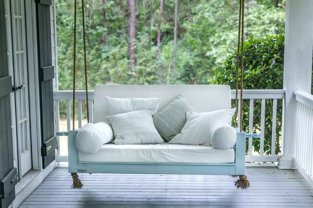 blue porch swing hanging from ropes