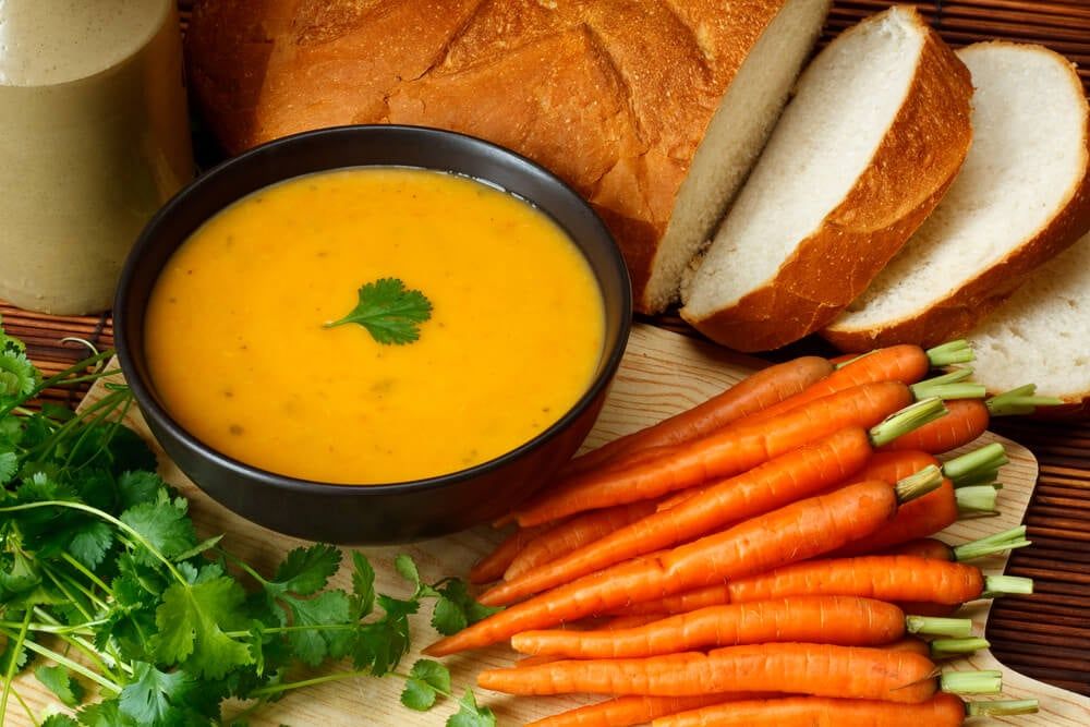 homemade coriander and carrot soup with fresh bread