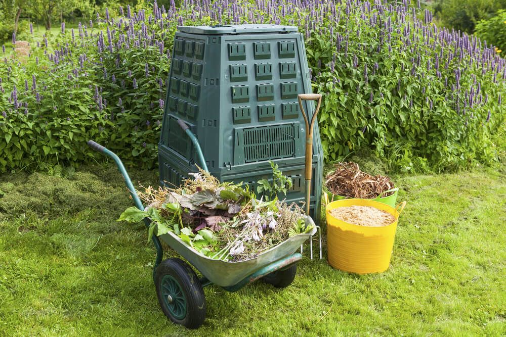 wheelbarrow with compost bin in the garden