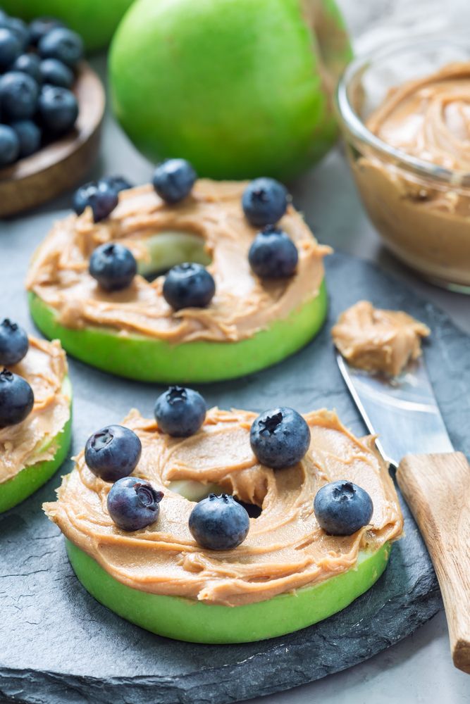 Chickens will love eating these apple slices with peanut butter and blueberries