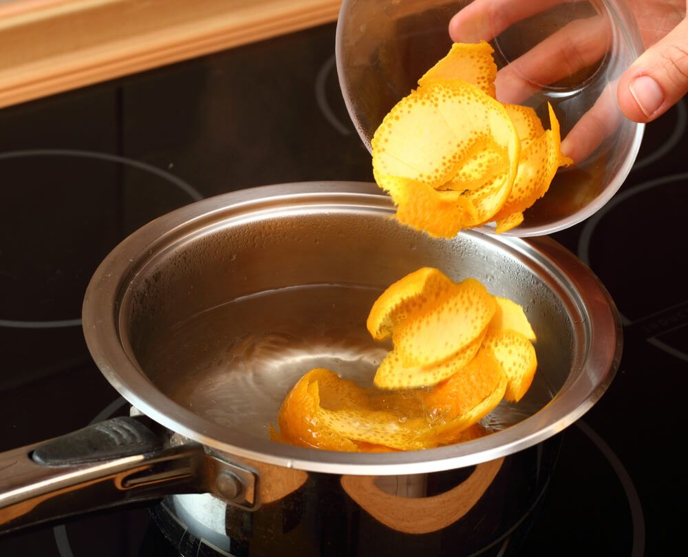 orange peels boiling in saucepan with syrup