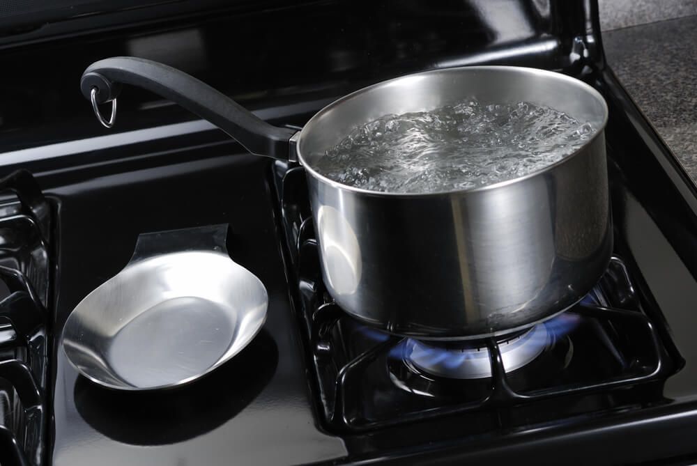 boiling water in stainless steel pot on stovetop burner