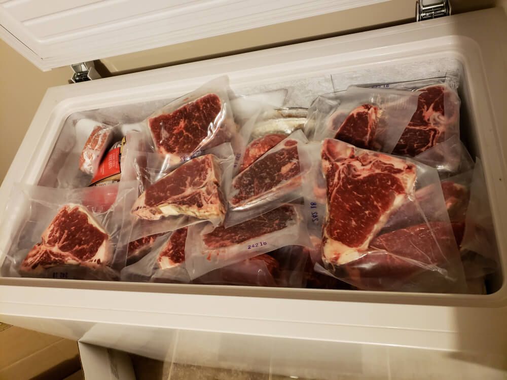 chest freezer stuffed with lots of yummy steaks