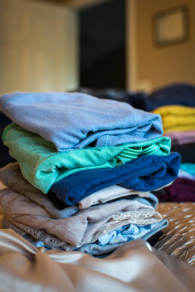 colorful and clean folded laundry on bed