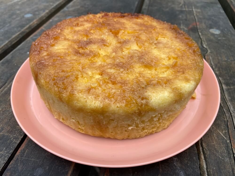 delicious looking baked pineapple cake on timber picnic table
