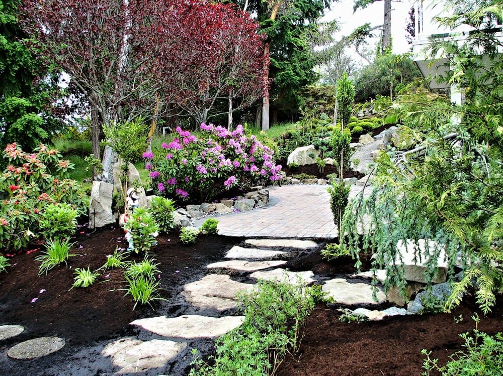 gorgeous backyard garden oasis with walking path and stepping stones