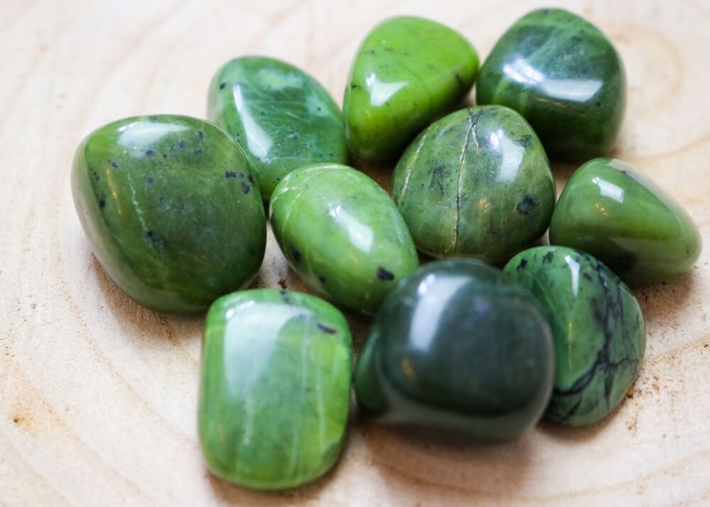 lovely green jade crystals shimmering on a wooden surface