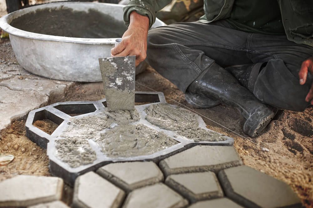 pouring cement into patio paver molds