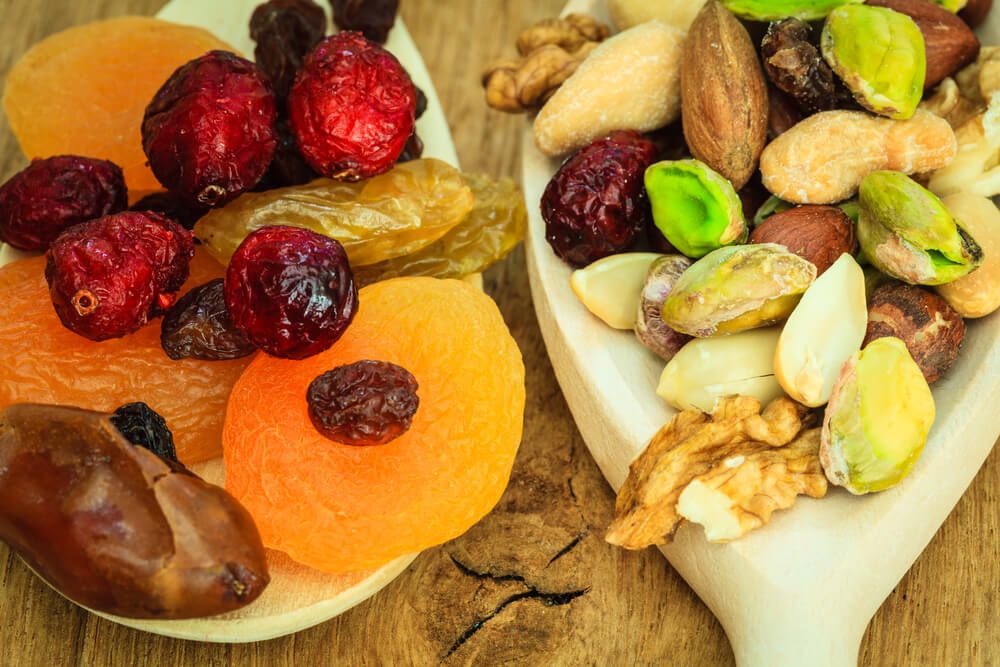 yummy organic dried fruit and nut mix on wooden spoons