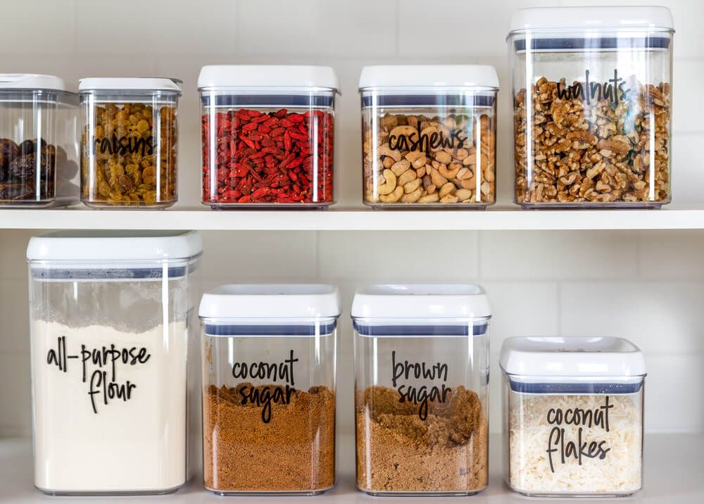 flour sugar nuts and kitchen ingredients stored neatly in plastic containers