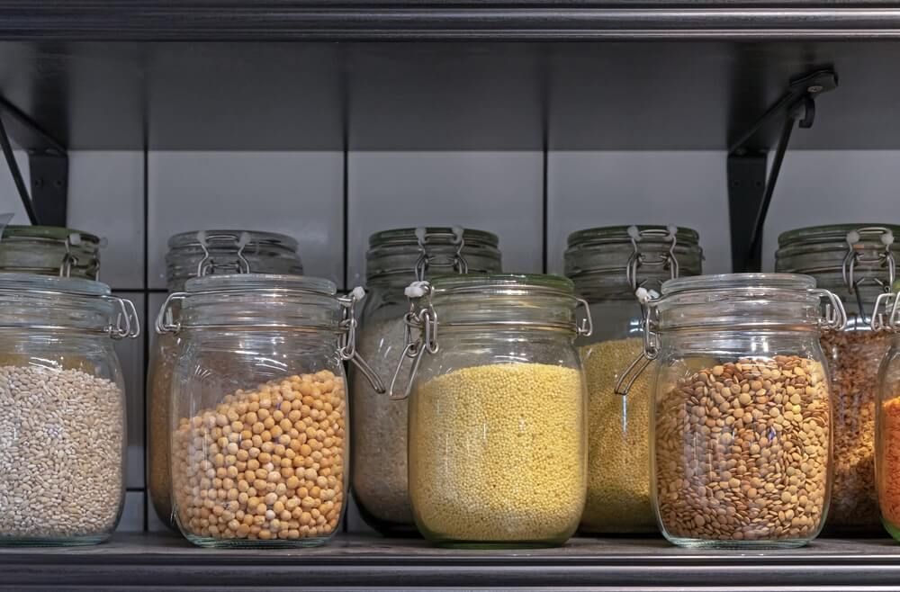 home food storage jars stuffed with various cereals and grains
