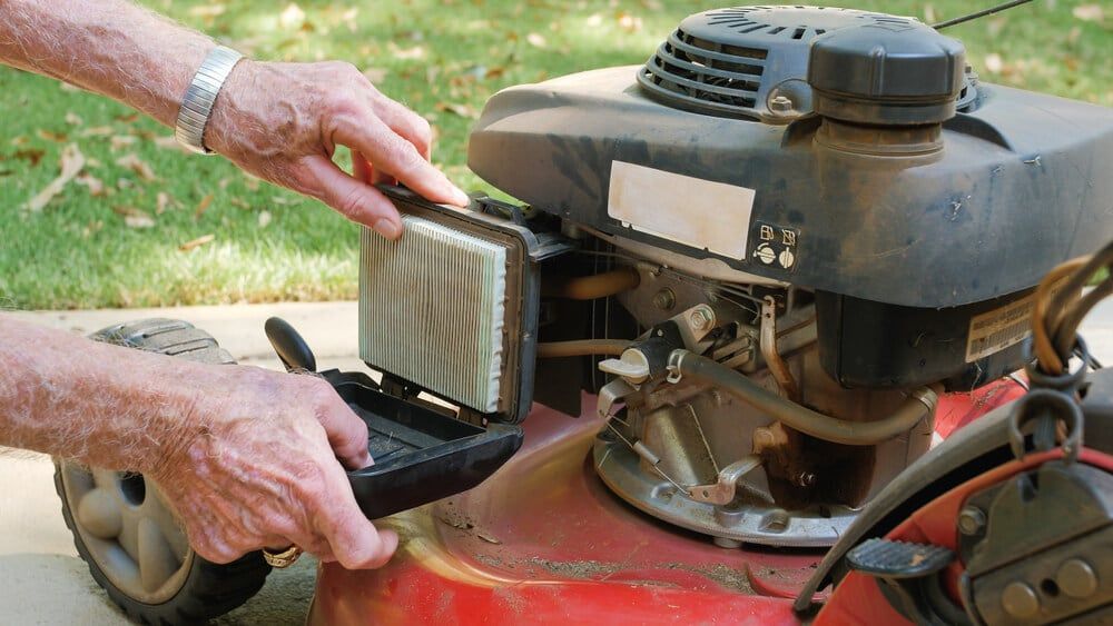 replacing air filter on gas lawn mower for routine maintenance