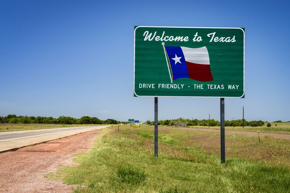 welcome to texas state sign reminding drivers to drive friendly
