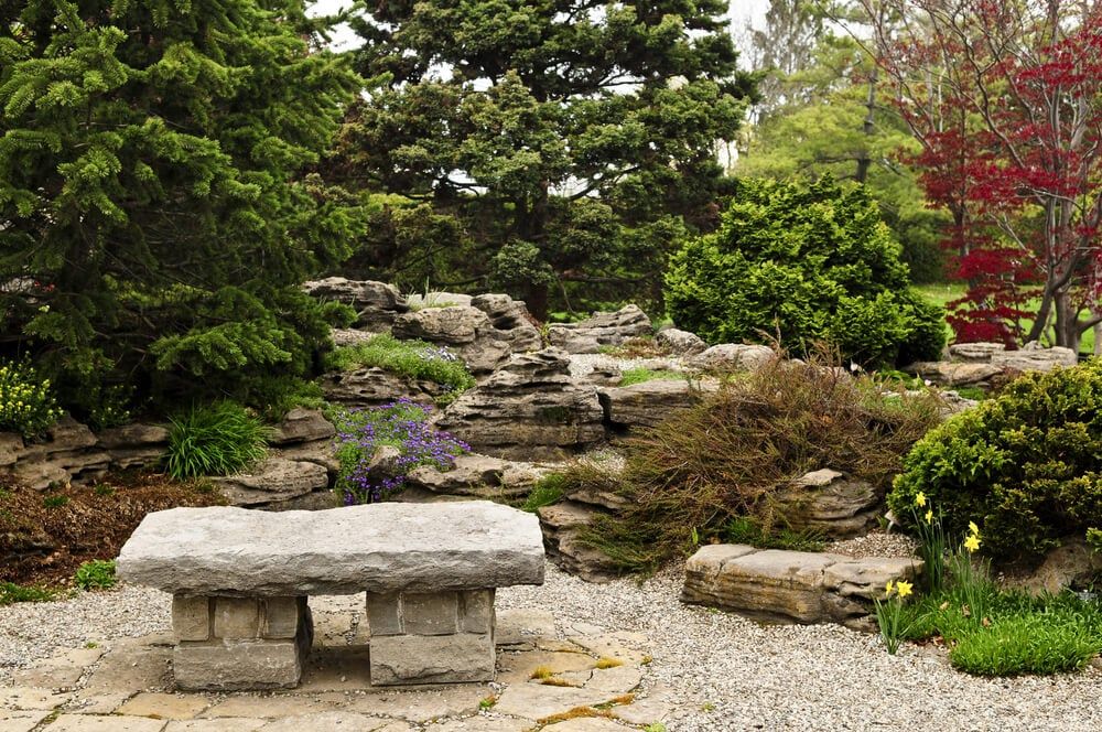 zen garden with a natural stone bench