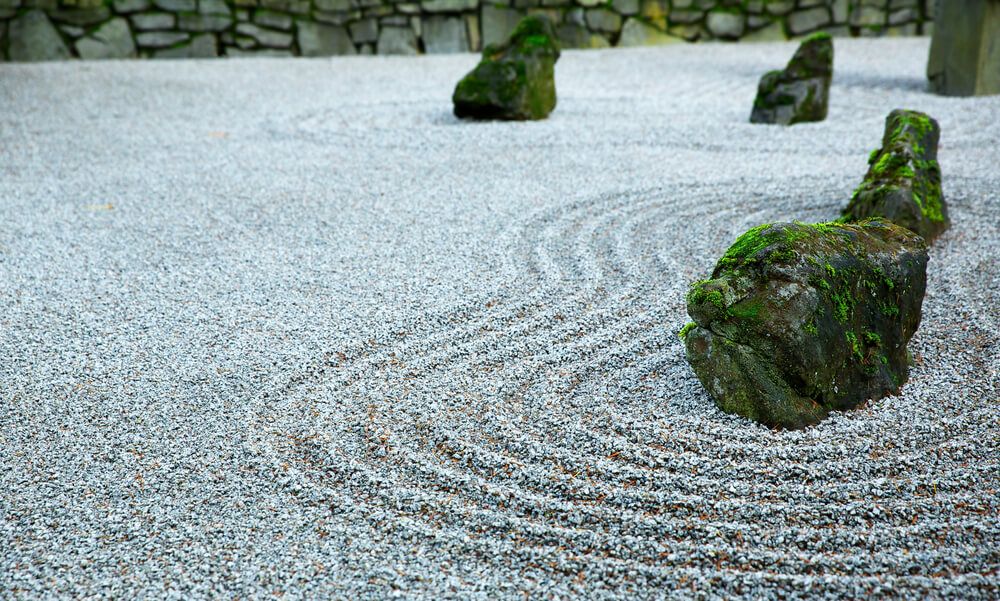 zen garden with mossy rocks on a dark cloudy day