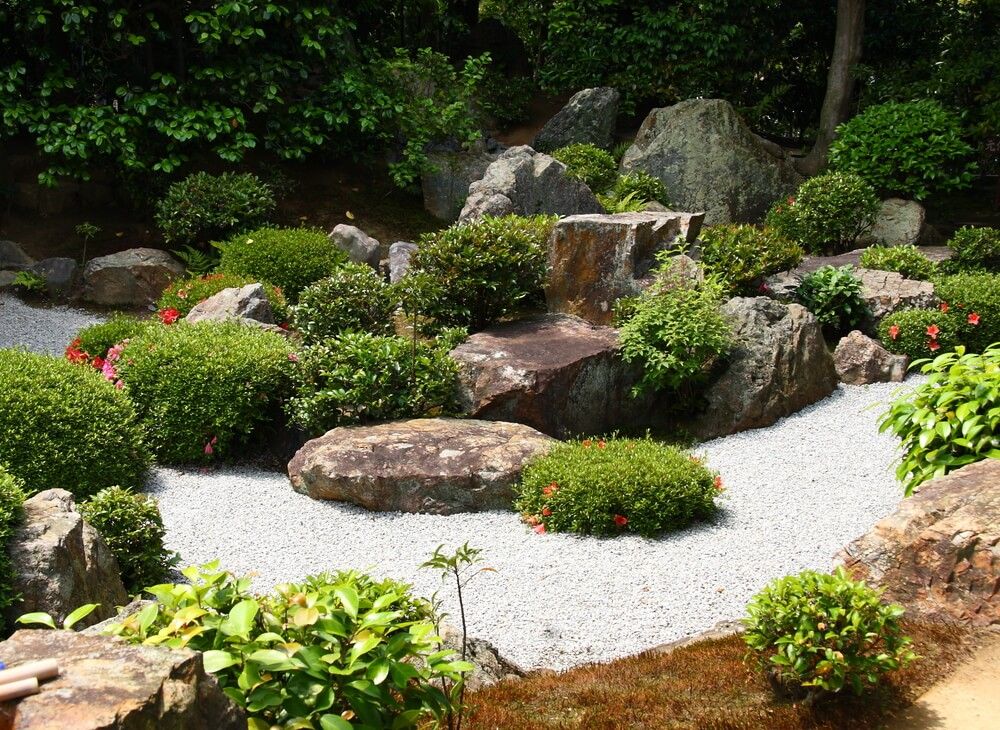 zen garden with rocks and shrubs on a beautiful sunny day