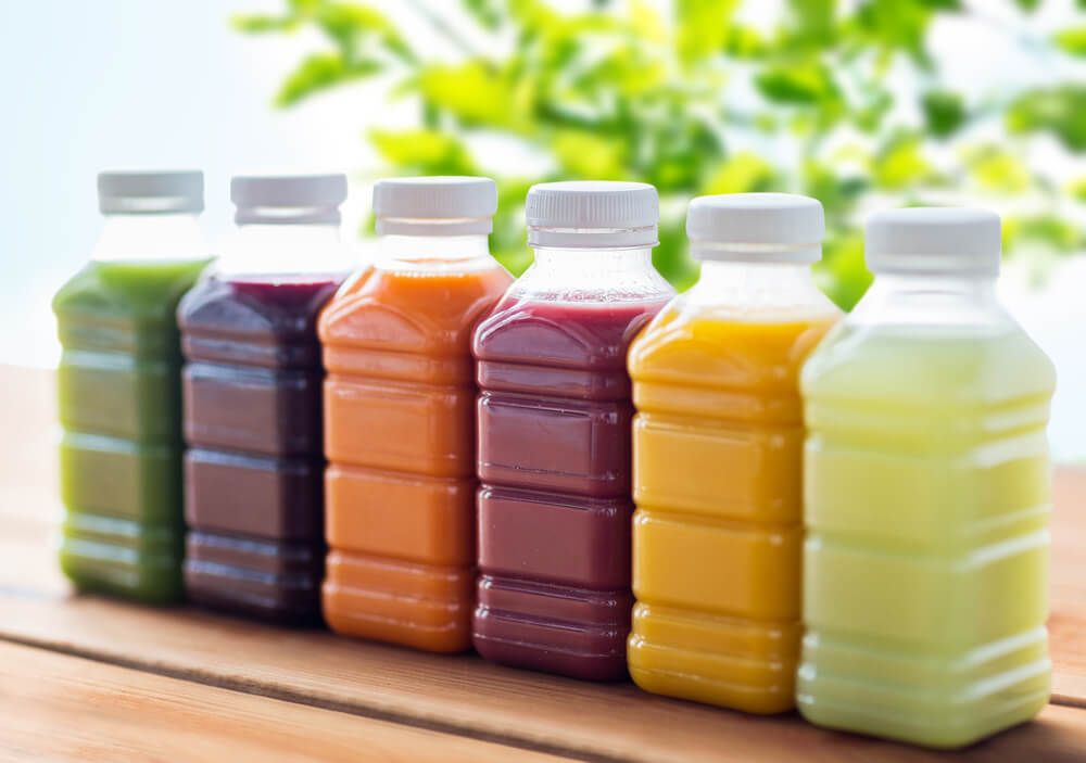 healthy and colorful fruit and vegetable smoothies in food grade plastic bottles