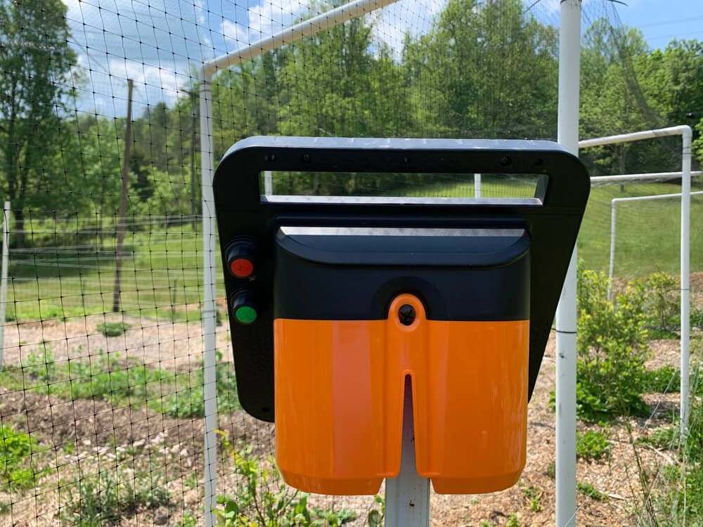 A solar electric portable fence energizer hooked up to an electric fence.
