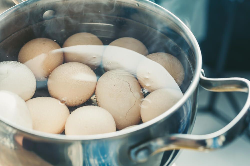 boiled eggs simmering in the water