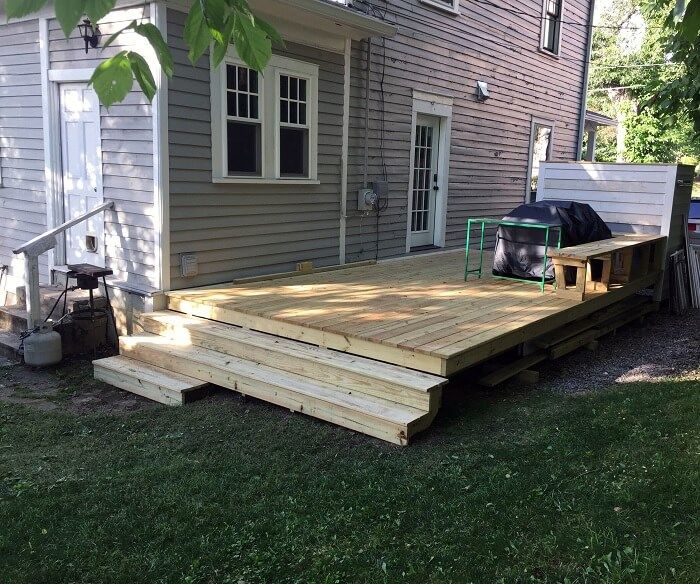building a lovely backyard deck on a beautiful day