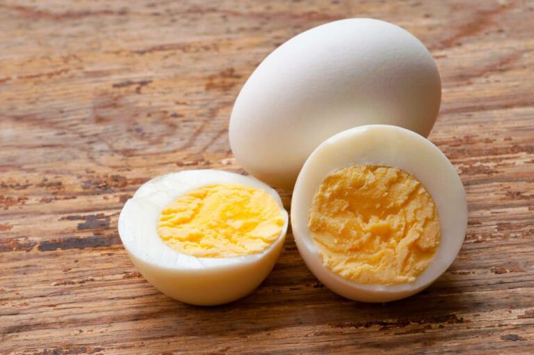 yummy looking hard boiled eggs resting on a wooden table