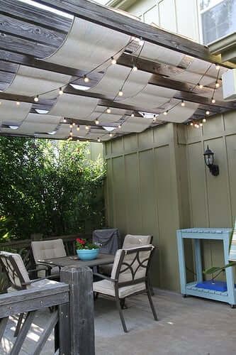 A lovely and shady pergola with a fancy ceiling.