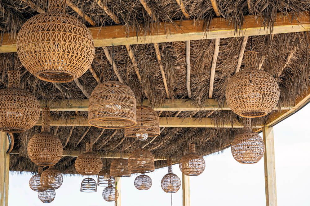 Using many wicker lampshades as a porch or pergola ceiling decor theme.