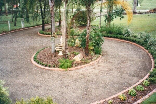 Excellent circular driveway design with a tropical theme.