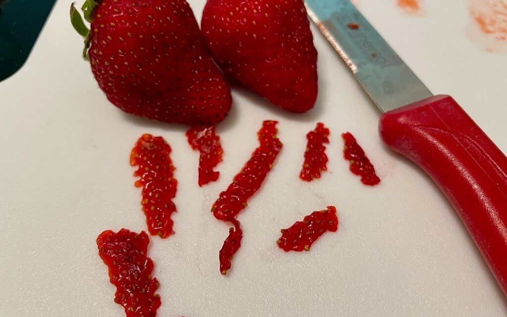 Strawberries sliced into strips to dry and extract the seeds